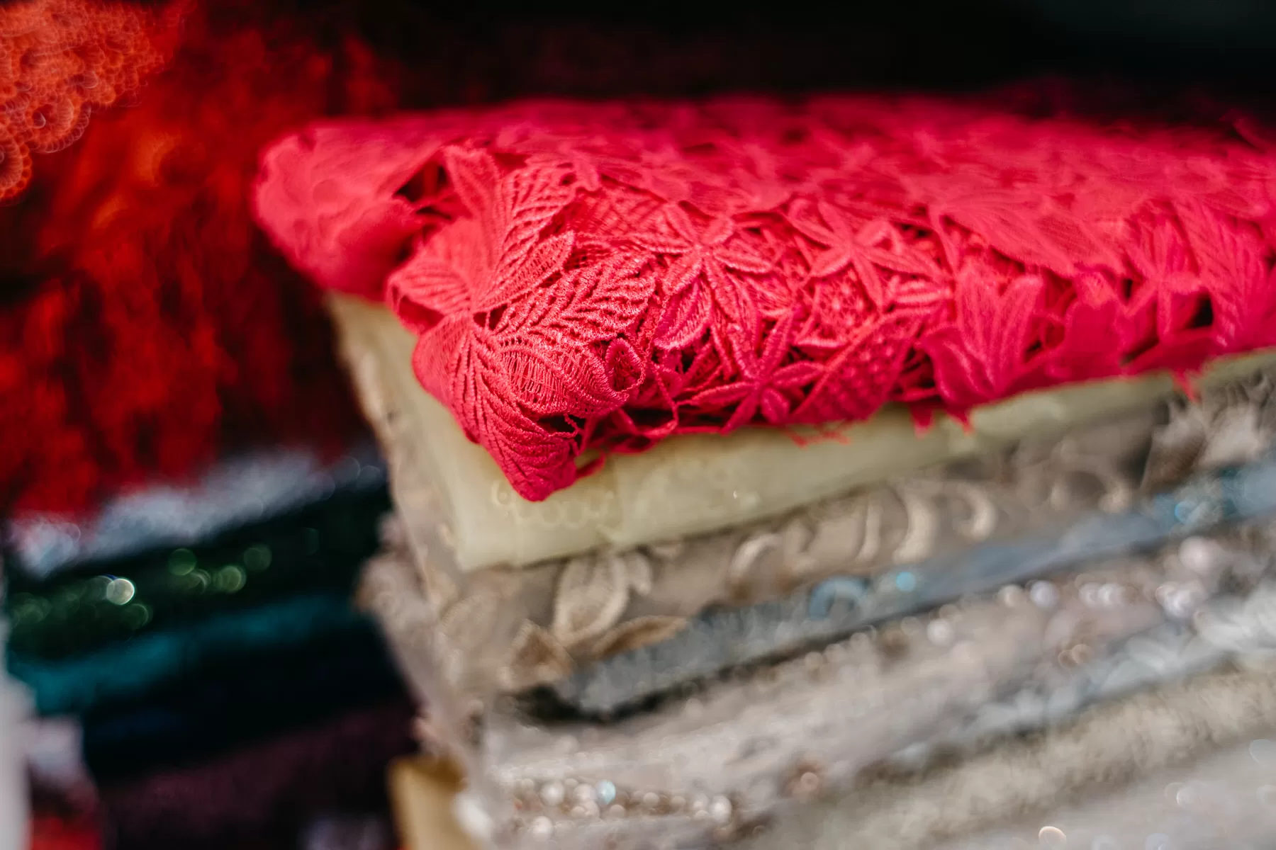 A behind the scenes photo of Celine Ooi meticulously working on a bridal gown during the video shoot. by cliff choong