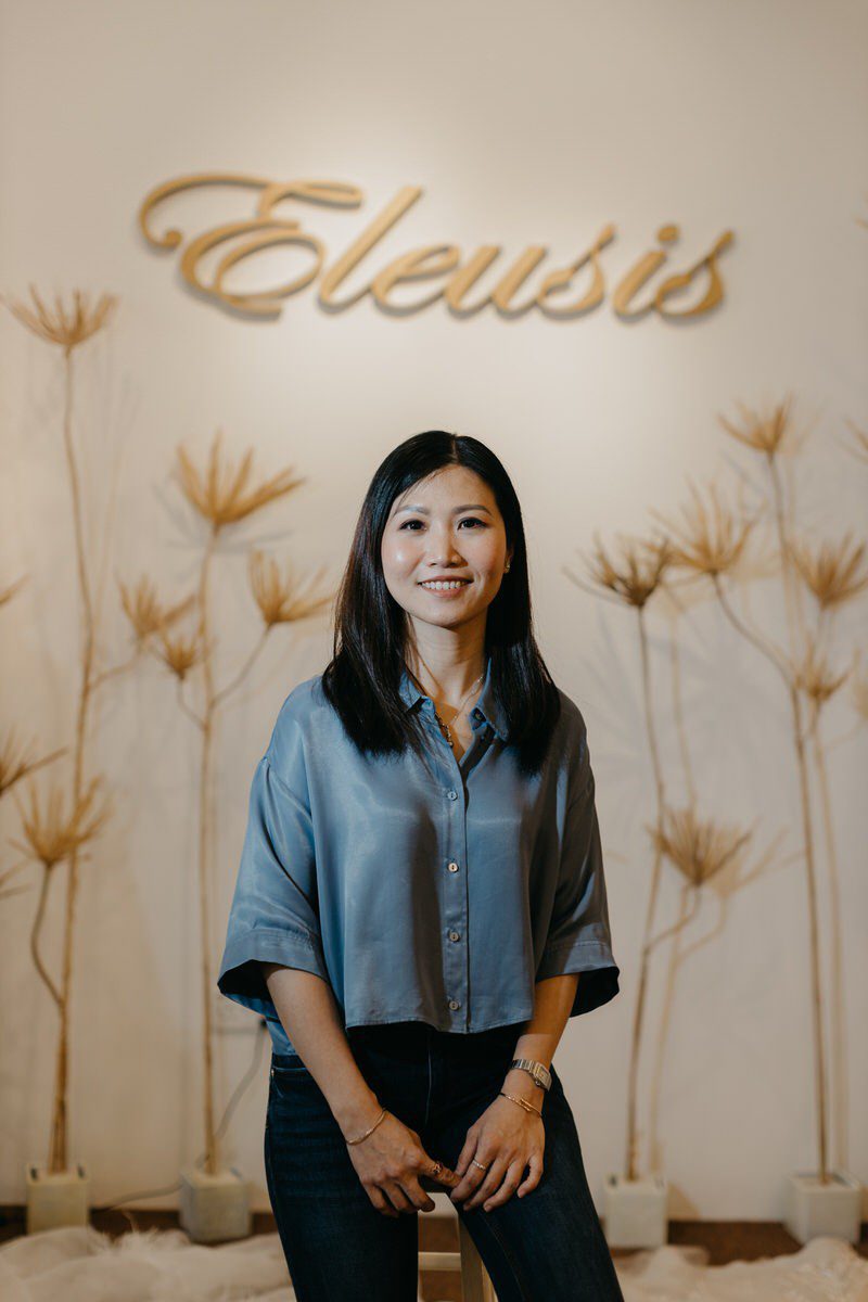 A person posing in a professional attire, representing traditional headshots.