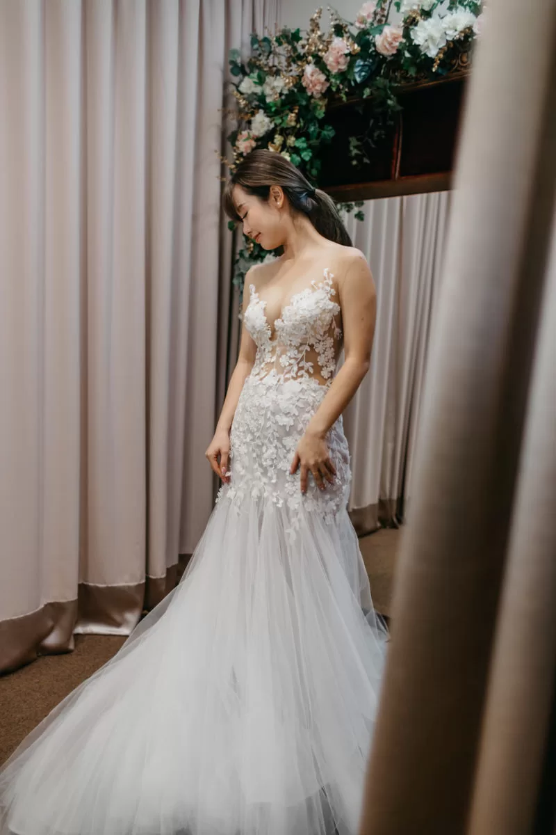 Model radiating confidence in a stunning Celine Ooi bridal gown. Model trying on one of Celine Ooi's elegant gowns during the photo shoot. by cliff choong