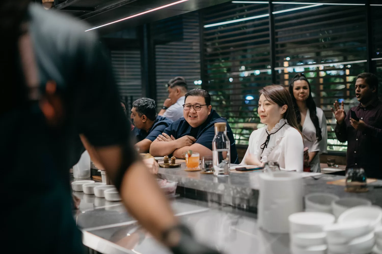 Smiling guests enjoying the delectable creations and lively atmosphere.